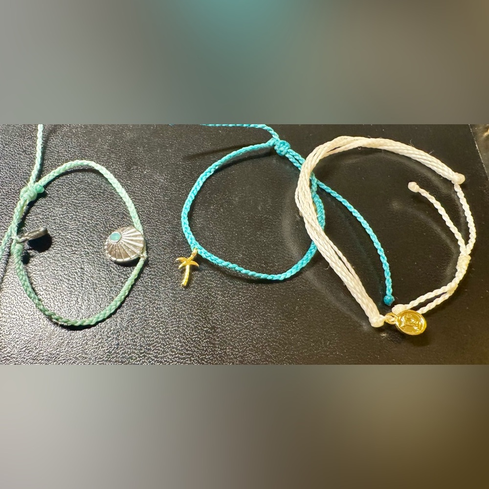 Set of 3 Pura Vida bracelets. 2 with charms